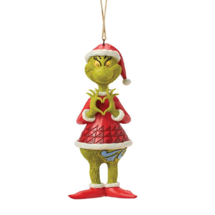 Grinch Christmas ornament featuring the Grinch in a red Santa hat and red dress with white trim, holding his hands in the shape of a heart, on a white background.