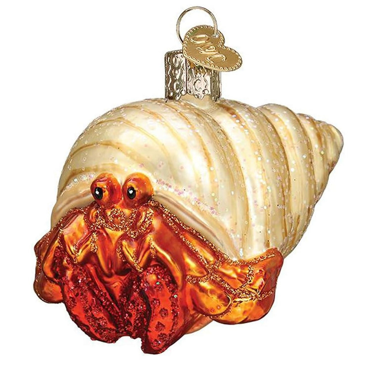 blown glass ornament of red hermit crab with tan shell, and glitter embellishments.