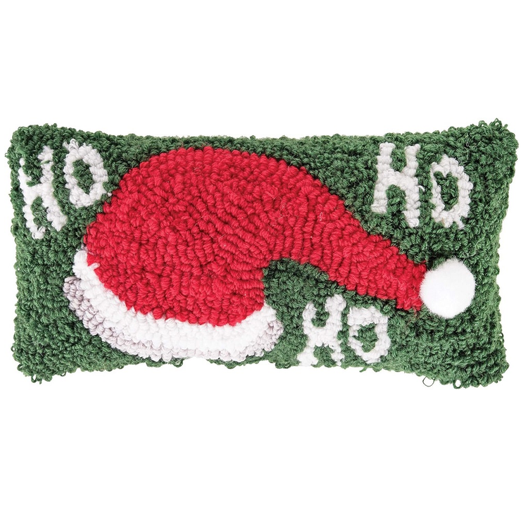 Decorative pillow with a red Santa hat and 'Ho Ho Ho' text on a green background