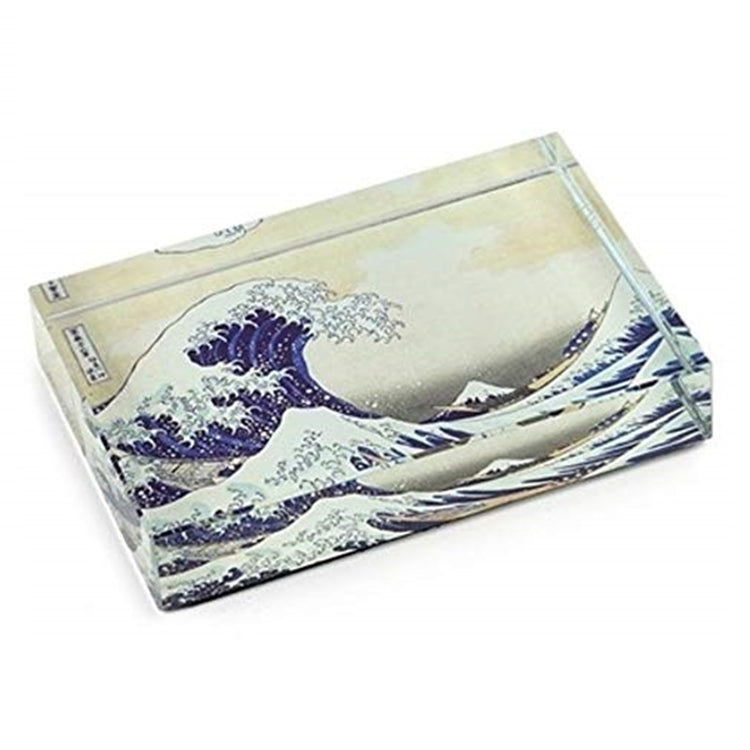 Rectangle shaped crystal paperweight with a picture of a great wave in blue with white foam.