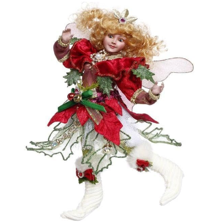 Decorative fairy figurine with red and green attire on a white background