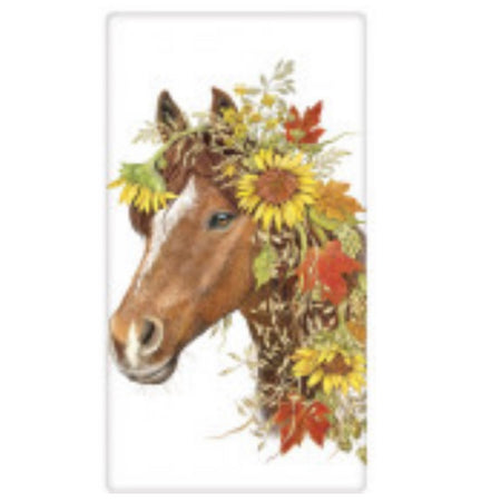 White kitchen towel with horse head design. Horse is brown and white with fall flowers like  crown and hangs down. Orange fall leaves and yellow sunflowers.