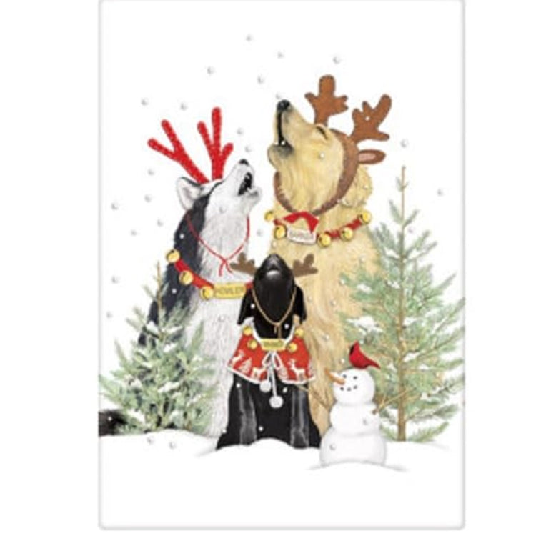 white kitchen towel with 3 dogs howling, they are dressed for Christmas in bells, antlers and a sweater. 2 evergreen trees a snowman and a red cardinal.