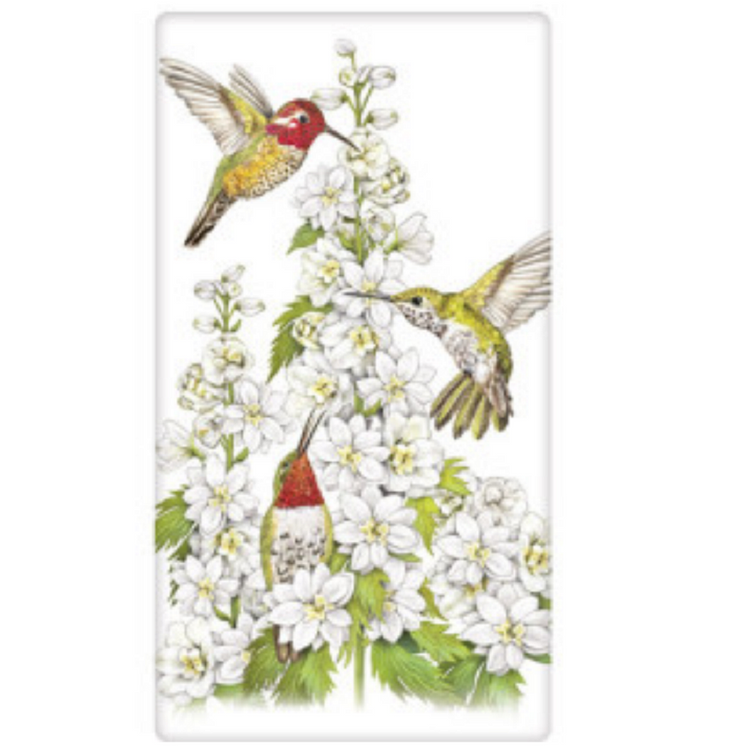 white flour sack dish towel with white flowers and 3 colorful hummingbirds feeding.