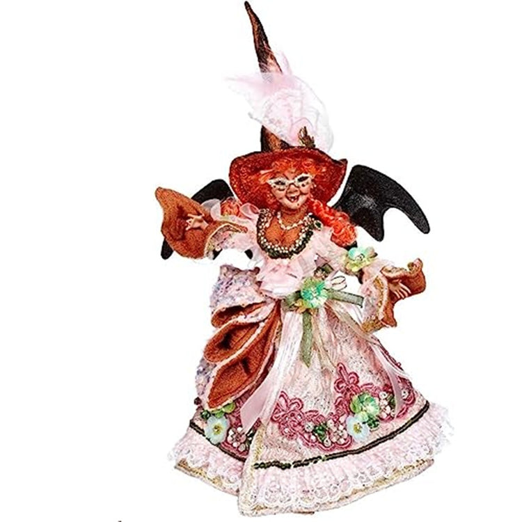 witch figure with a long pink dress embellished with ric-rak and flowers.  red hair the wings and tall witch hat