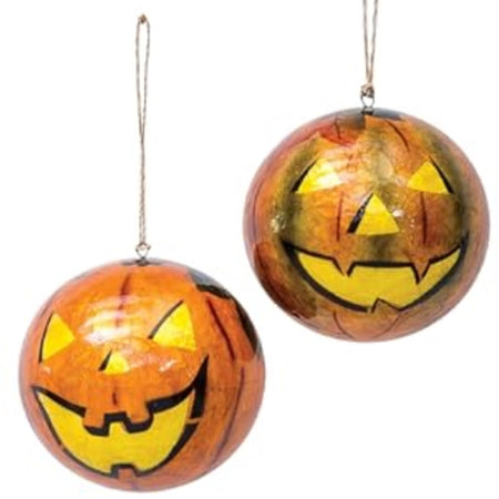 2 round ornaments in orange with jack o lantern faces drawn on in black.