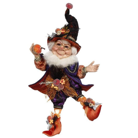 bearded elf in withces hat, dark purple suit with orange lining, orange boots, and holding a glittery pumpkin.