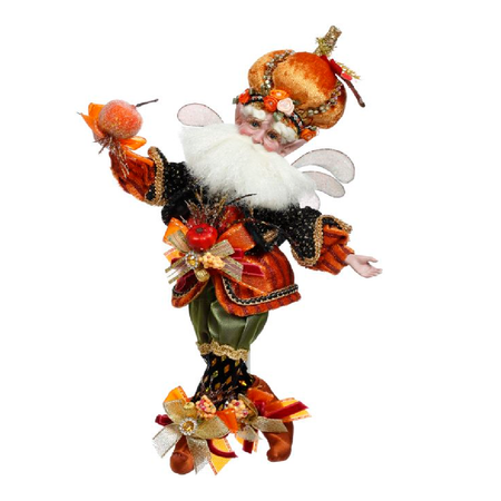 Bearded fairy wearing orange and black outfit with pumpkin accents, a pumpkin shaped hat and holding a small pumpkin.