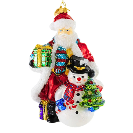 A festive Christmas ornament depicting Santa Claus carrying a snowman and a small glittery Christmas tree, with wrapped gift boxes, on a plain white background.