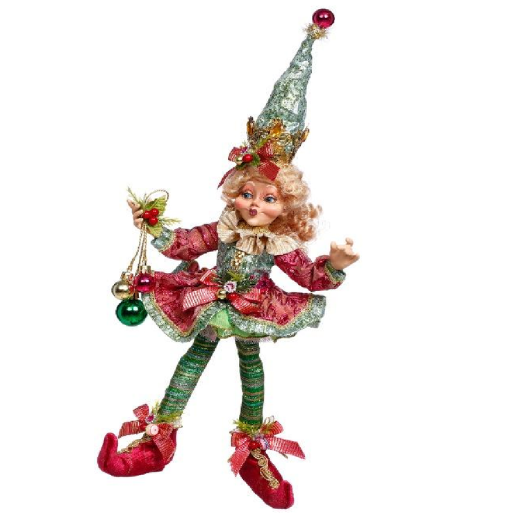 girl elf in green and red dress, holding 3 ornaments on a ribbon.