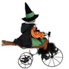 side view Karen Didion Margaret's Biking Venture 18-inch Halloween witch figurine riding a vintage-style tricycle with a black cat, pumpkin cauldron, and Trick or Treat sign.