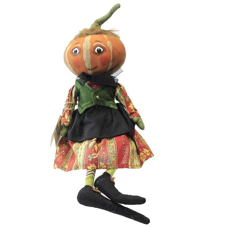 pumpkin head girl figurine, wearing paisley dress with black apron and a green vest.