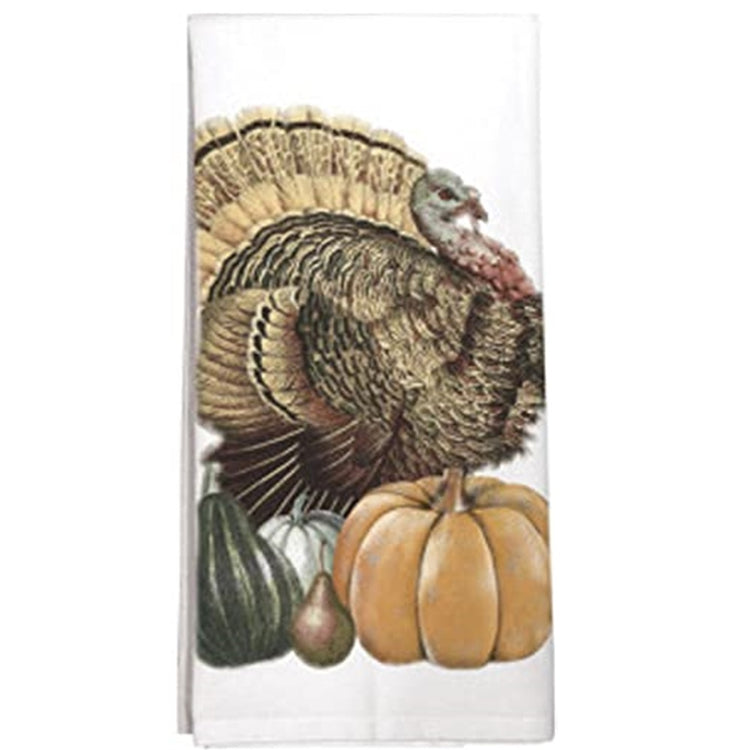 Folded white kitchen towel with a turkey a pumpkin and 3 squash