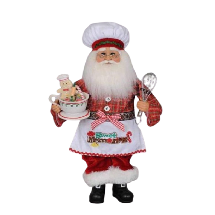 collectible santa figurine wearing chef hat and apron, holding a whisk and mug with cookies.