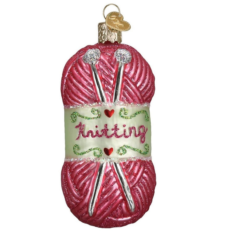 blown glass pink knitting yarn with knitting needles, hand painted with glitter accents.