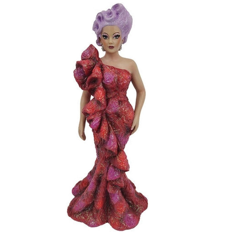 Resin drag queen figurine with lavender hair and a sparkly red dress.