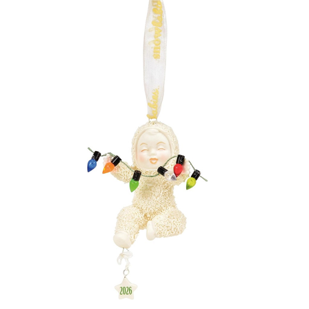 Snowbaby ornament holding a string of faux christmas lights, there's also a star charm with the year 2026.