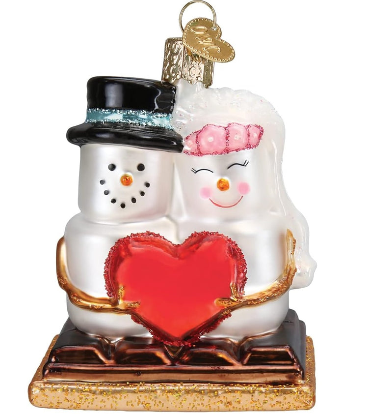 Blown glass ornament of 2 smore snowman, a bride and groom.