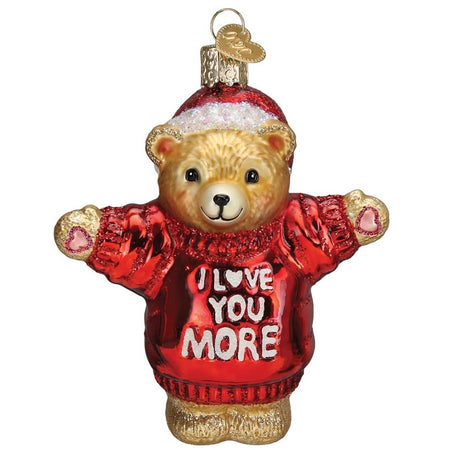 blown glass teddy bear ornament, he's in a red hat and sweater that says "I love you more"