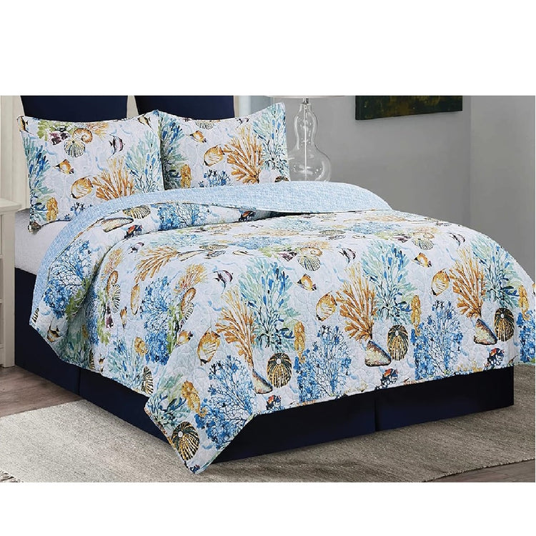 Photo shows a bed with a matching quilt and 2 shams.  Th pattern is god and blue coral on white background with shells and sealife.