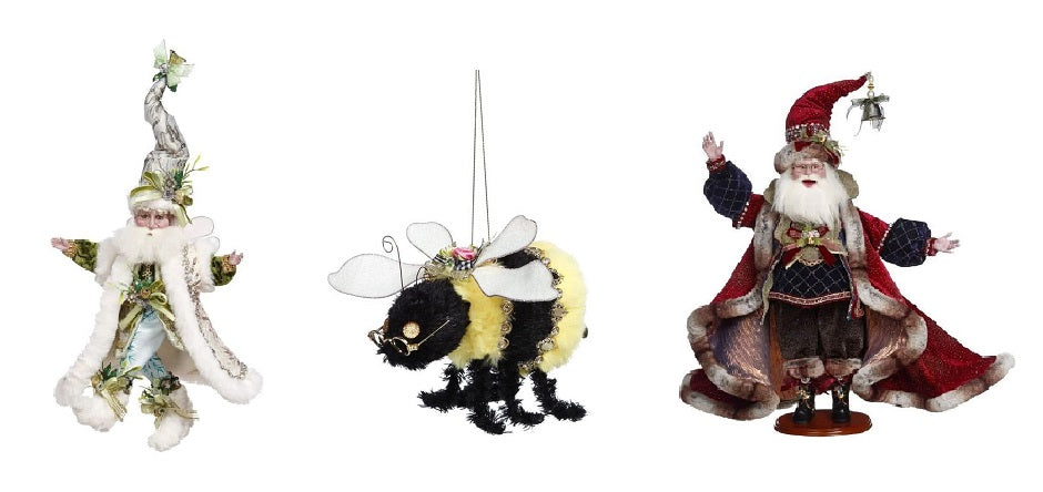 Fairy wearing a long white coat, a bumble bee ornament and a Santa figure wearing a full red coat