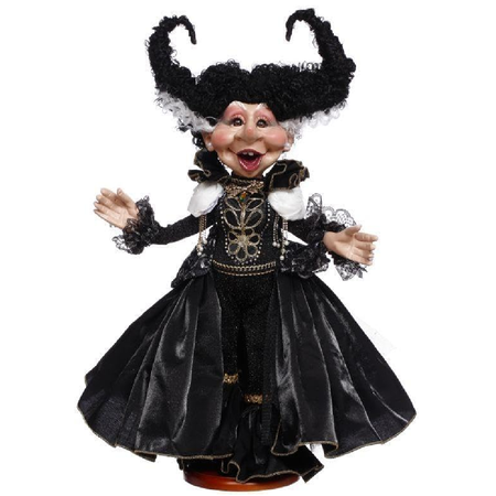 Decorative figurine in a black dress with intricate details on a white background