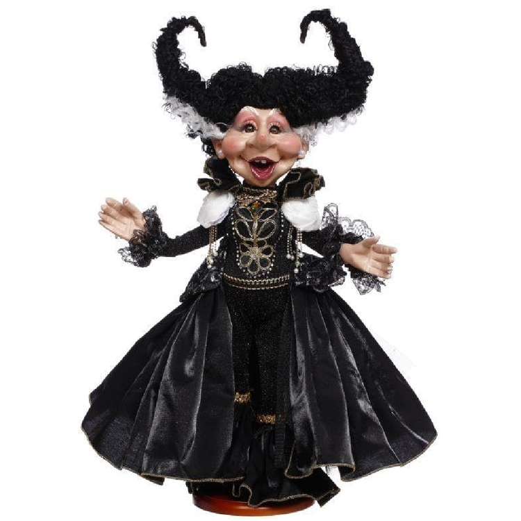 Decorative figurine in a black dress with intricate details on a white background