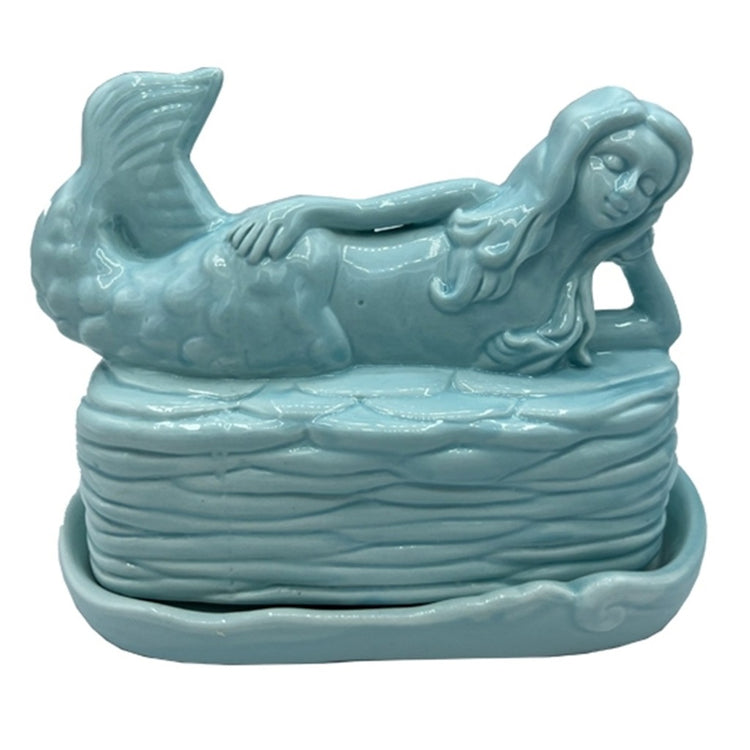 Butter dish with tray and lid.  Solid aqua color. The handle to the lid is a mermaid lying on her side with long hair and a full tail.