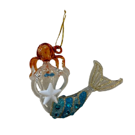 orange haired blown glass mermaid holding a white starfish, tail is blue and gold glittered.