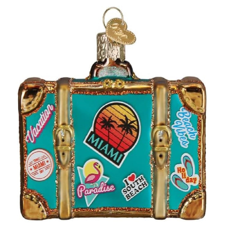 blown glass blue vintage inspired suitcase, with miami stickers on it.