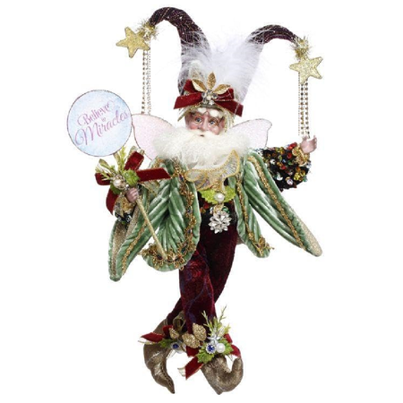Decorative fairy figure with festive attire and 'Believe in Miracles' sign on a white background