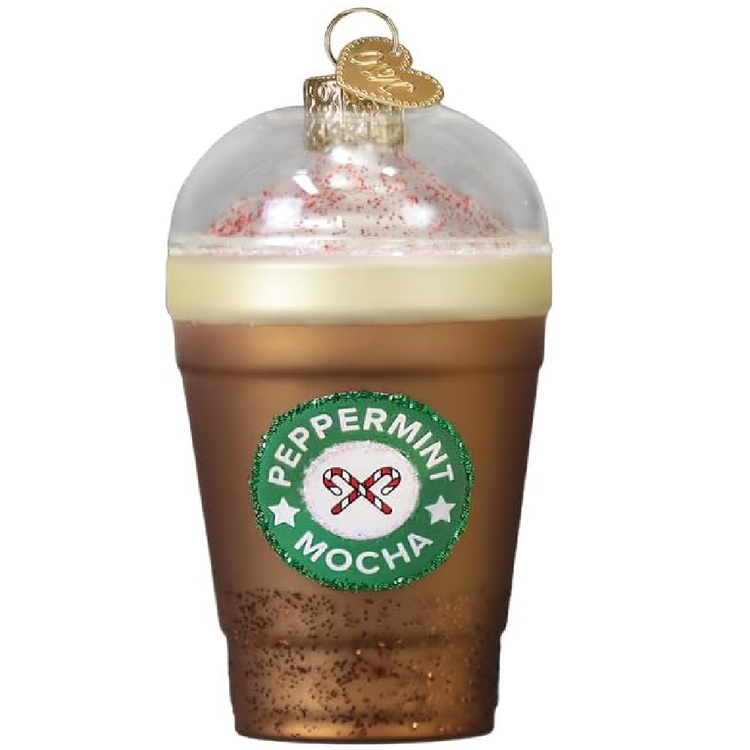 Blown glass ornament of a Peppermint Mocha drink in a clear cup, with red sprinkles and whipeed cream.