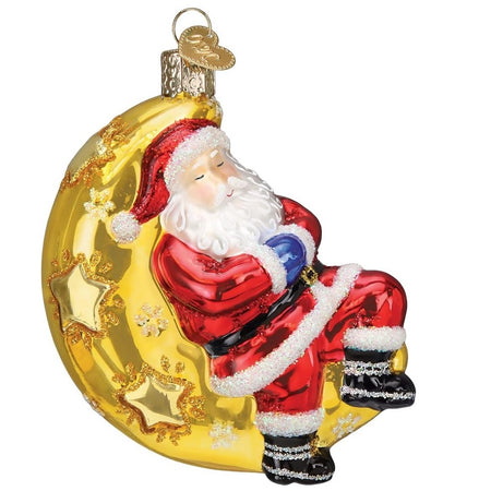 blown glass ornament depicting Santa sleeping in a crescent moon.