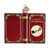 front and back cover of a book shaped ornament in red with gold lettering The Night Before Christmas .  There is a graphic of a moon with Santa  and his sleigh flying by.