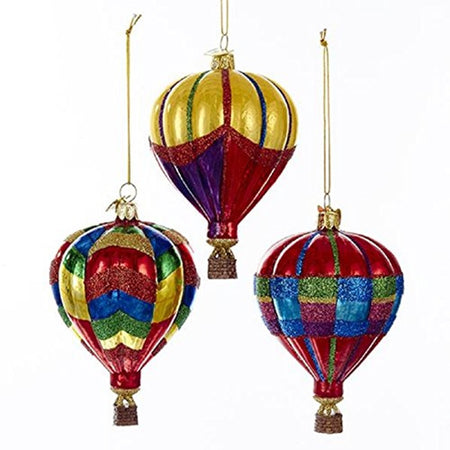 3 hot air balloon ornaments in coordinating colors of red blue green and gold in different patterns with glitter finish