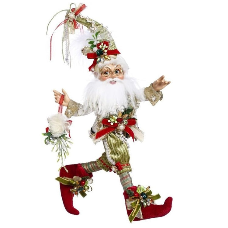 bearded elf wearing green suit, red boots, and a coordinating hat with mistletoe sprigs. He's holding a swag made of flowers and misteltoe.