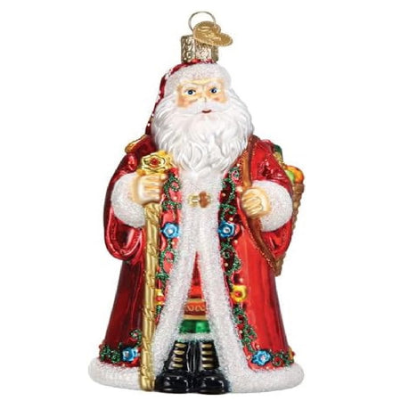 Blown glass ornament, Santa in long red coat with floral design, holding a gold walking staff and a basket of goodies on his back.