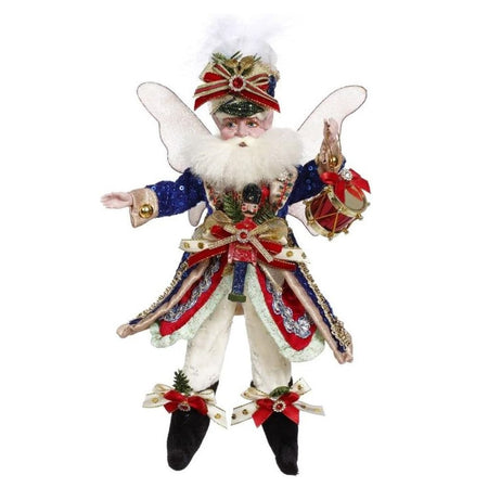 Bearded fairy in a red and blue military style jacket, with a nutcracker accent, the fairy is holding a drum.