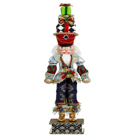 Nutcracker figurine with a hat made of 3 presents stacked on top of each other.