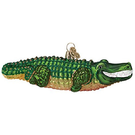 Ornament shaped like an alligator wit ha green back, gold underbelly and smiling white teetch.