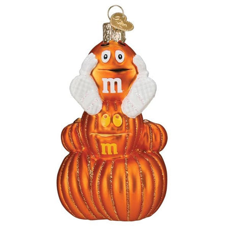 ornament with stacked orange pumpkins wiht an orange m&m candy on top wearing white shoes and white gloves