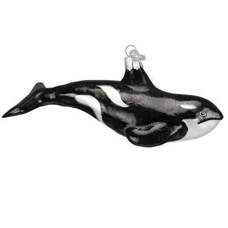 blown glass ornament depicting a black and white orca whale with glitter accents.