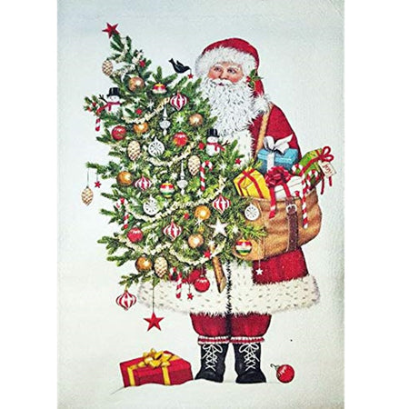 White kitchen towel with Santa standing holding a decorated tree and a satchel of gifts.