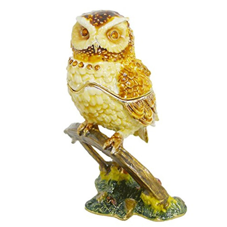 Golden owl perched on a branch. You can see where the owl opens to the box mid way through his body. Golds and browns.