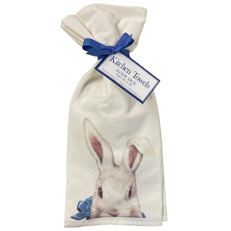 Two flour sack towels with white rabbit in a blue ribbon playing  peek a boo.