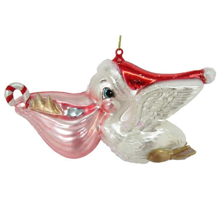 blown glass pelican ornament wearing Santa hat. Pelican has candy cane and shell in his mouth.
