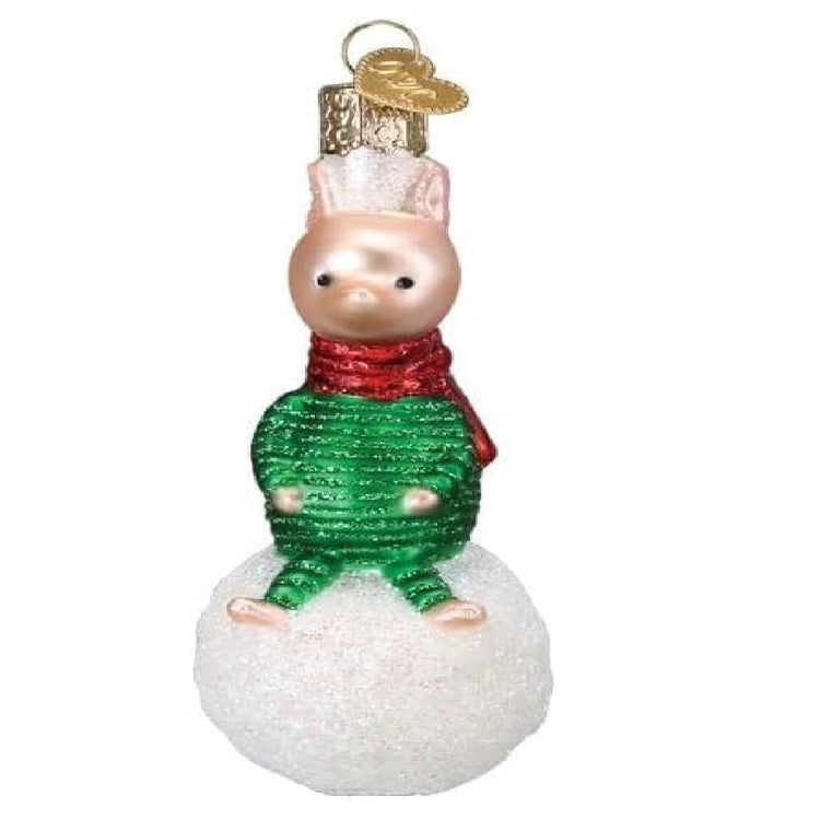 blown glass ornament of the classic character, Piglet, in his snow suit on top of a snowball.