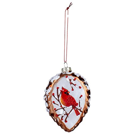 hanging ornament shaped like a pinecone cut in half. The flat side depicts a red cardinal on a pine branch with red berries.