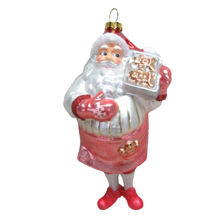 Blown glass Santa ornament. He is in a pink apron and mittens holding a tray of gingerbread cookies.