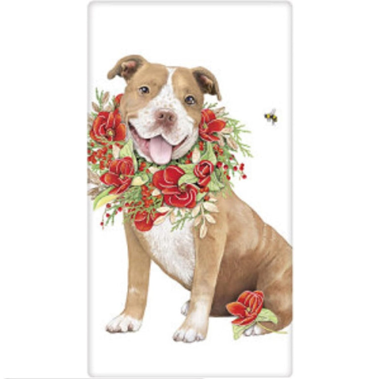 White towel with a tan and white Pitbull wearing a wreath of roses. Bumble bee near by